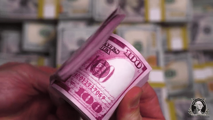 Stack of pink novelty money bills for themed events and decorations